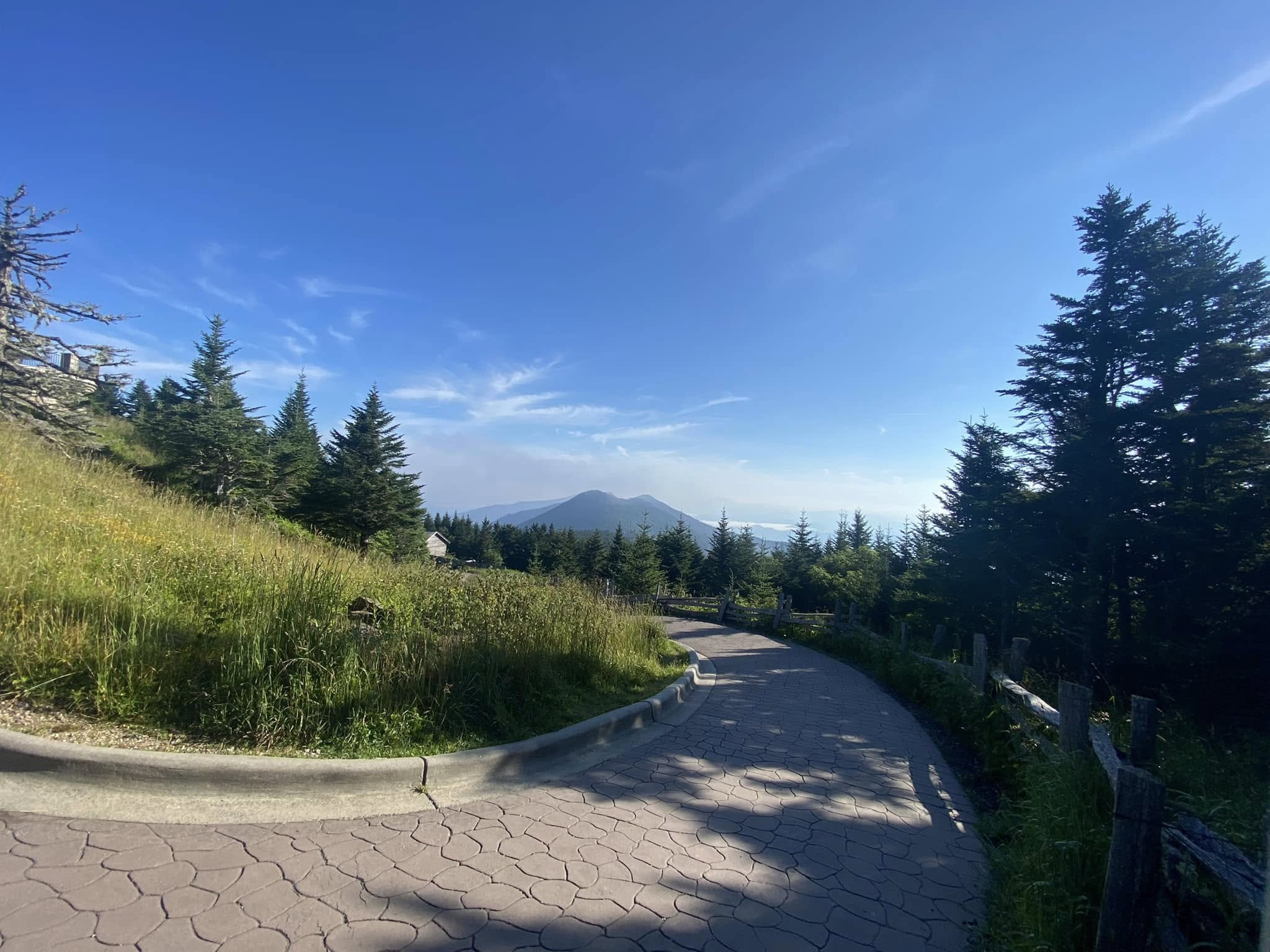Winding summit path with mountains in the distance