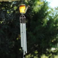 Solar wind chime lantern in a garden